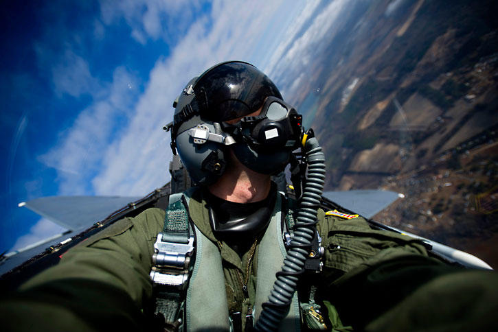 Pilot in the air with earth and sky in background